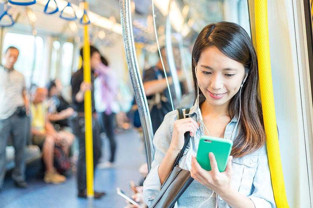 電車でスマホを使う女性